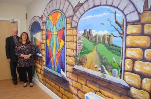 The Rev Gordon Newton and Glenys Jeff with the mural which she has created at the Beacon Church in Dover